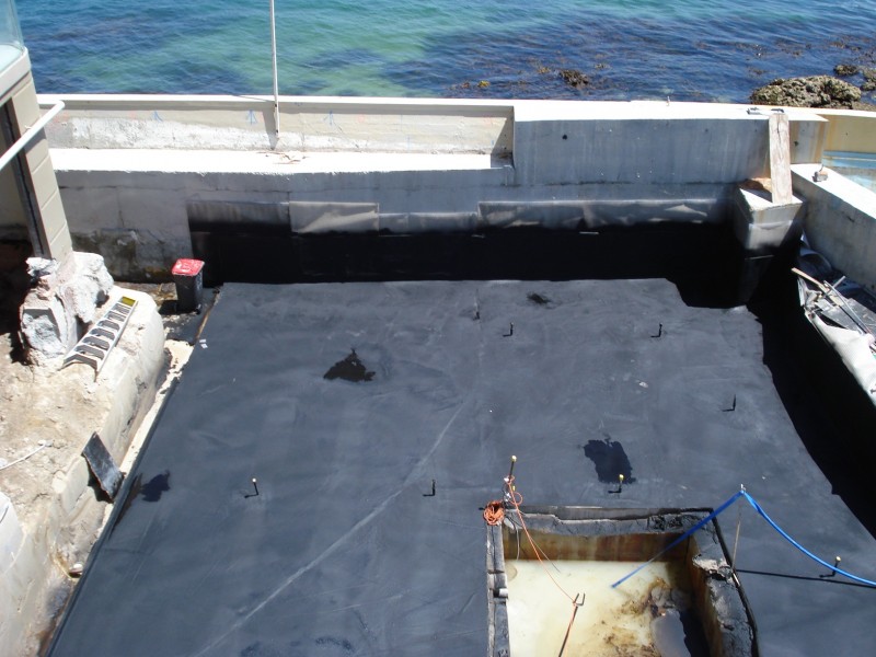 basement behind seawall waterproofed with cold spray-applied membrane