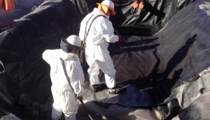 Cold spray-applied gas vapour membrane being applied onto geotextile